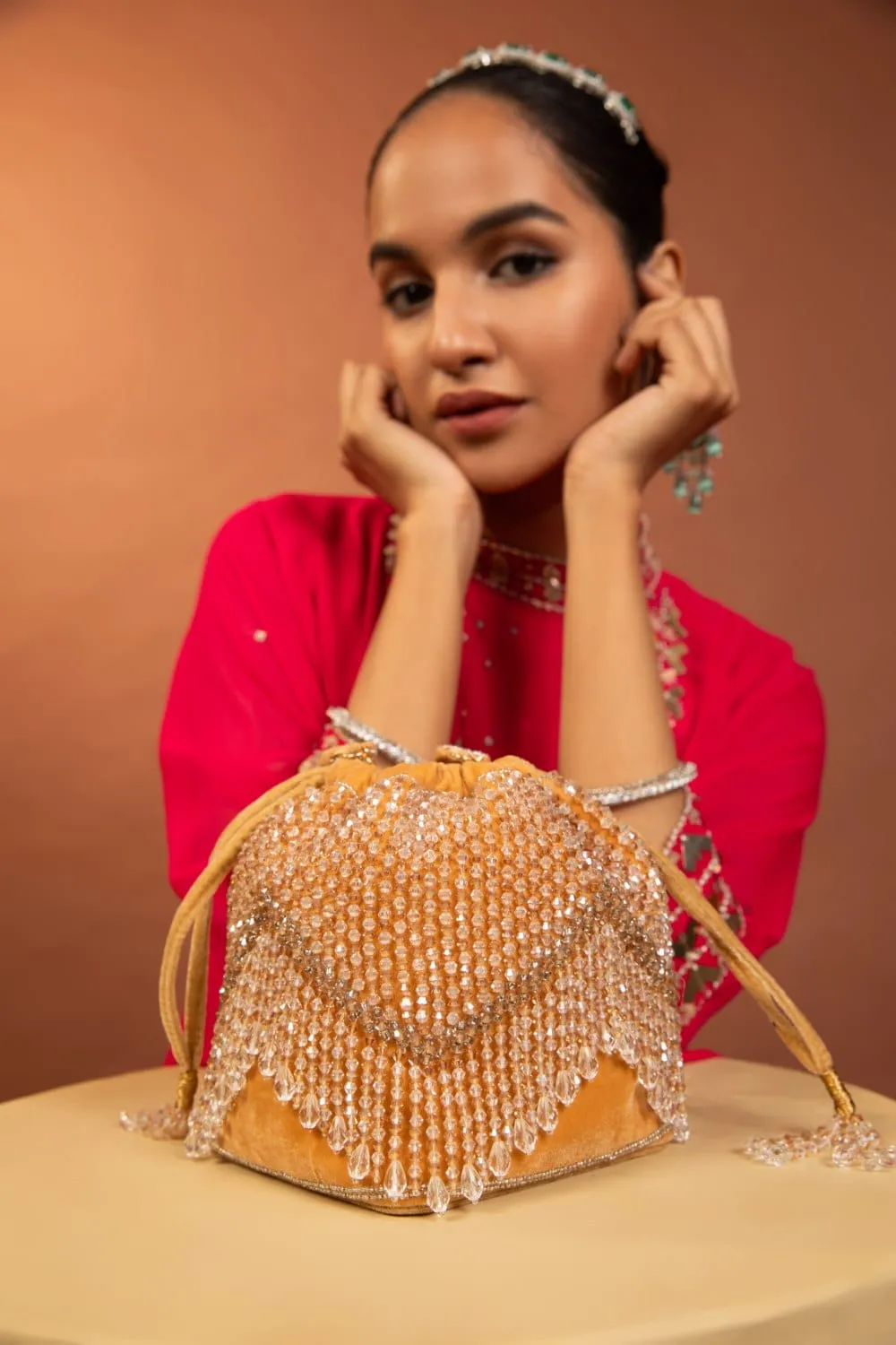 Elegant Golden Potli Bag With White Crystal Drops
